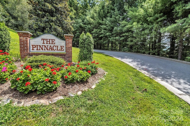 community / neighborhood sign with a yard