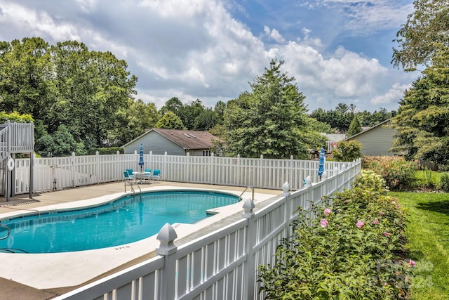 view of pool with a fenced in pool, a fenced backyard, and a patio