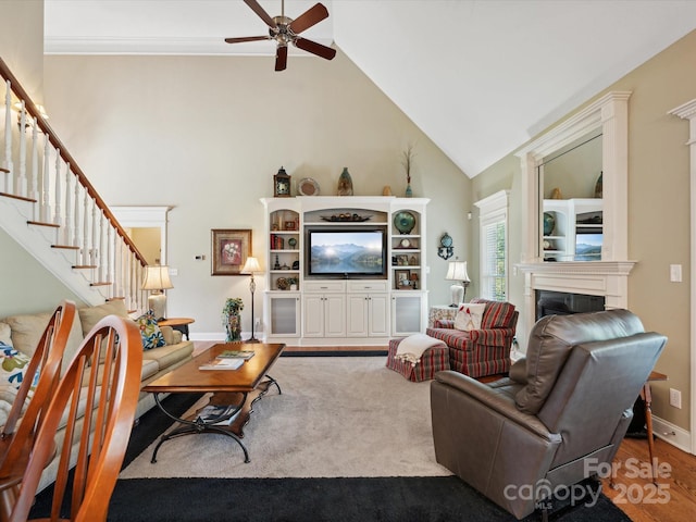 living room featuring ceiling fan and vaulted ceiling