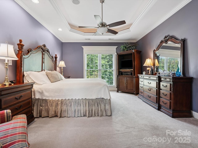 bedroom with light carpet, a raised ceiling, crown molding, ceiling fan, and multiple windows