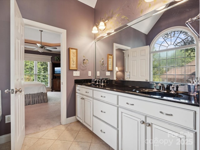 bathroom with tile patterned flooring, ceiling fan, lofted ceiling, and vanity