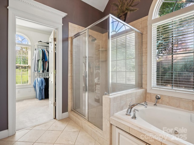 bathroom featuring tile patterned floors, plenty of natural light, and shower with separate bathtub