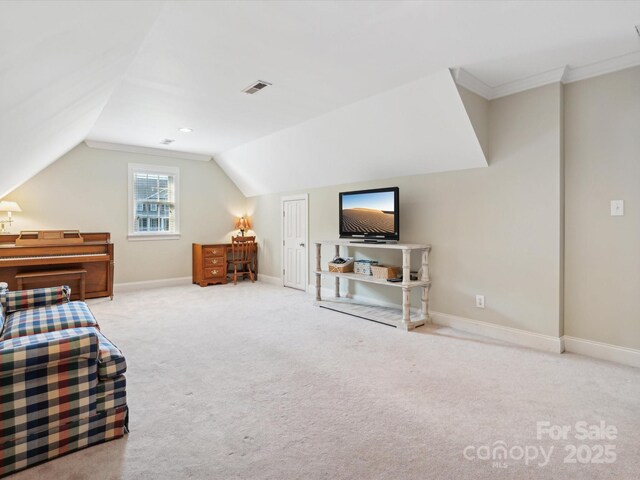 bedroom featuring crown molding, lofted ceiling, and light carpet