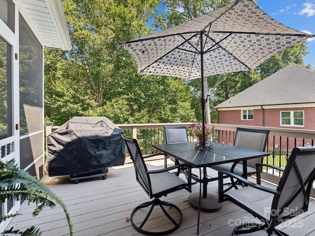 wooden terrace featuring a grill