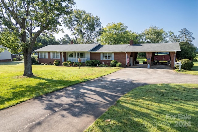 ranch-style house featuring a front lawn and a carport