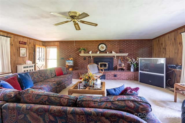 living room featuring a fireplace, brick wall, ceiling fan, and carpet