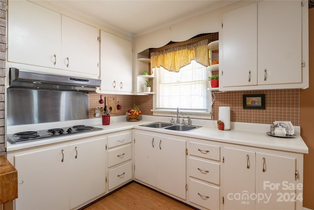 kitchen featuring light hardwood / wood-style flooring, backsplash, sink, and stainless steel electric stovetop