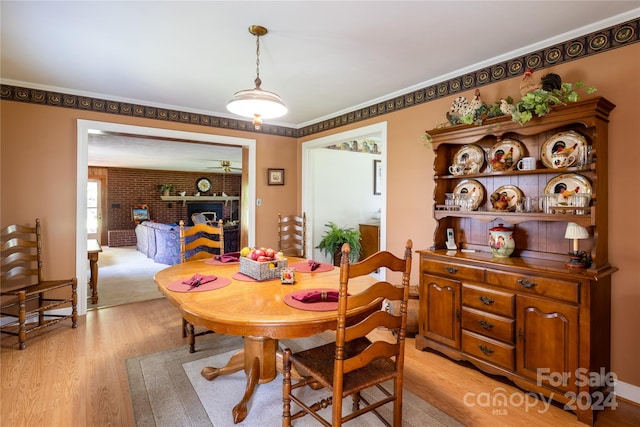 dining area featuring light hardwood / wood-style floors and crown molding