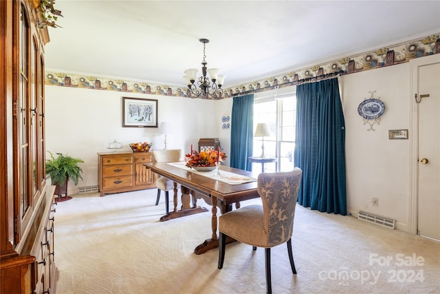 dining space with crown molding, a chandelier, and light colored carpet