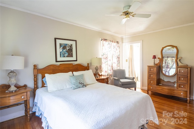 bedroom featuring crown molding, dark wood-type flooring, and ceiling fan