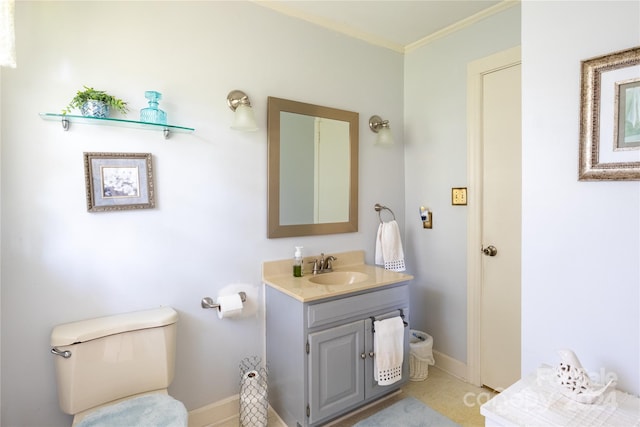 bathroom with ornamental molding, vanity, and toilet