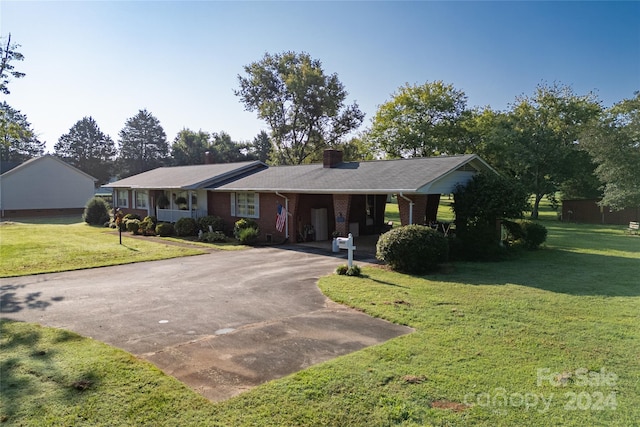 ranch-style home with a front lawn