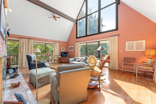 living room featuring high vaulted ceiling, beamed ceiling, and light hardwood / wood-style floors