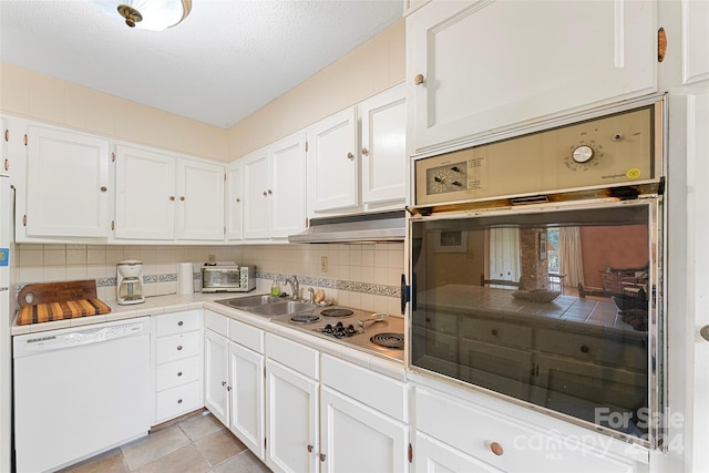 kitchen with white cabinetry, decorative backsplash, wall oven, and dishwasher