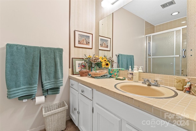 bathroom with vanity and tasteful backsplash