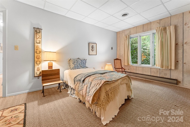 bedroom featuring a drop ceiling, carpet floors, and baseboard heating