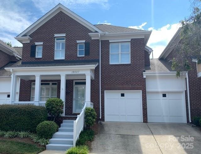 19307 Beaufain St, Cornelius, NC 28031 - traditional-style house with concrete driveway, covered porch, and brick siding