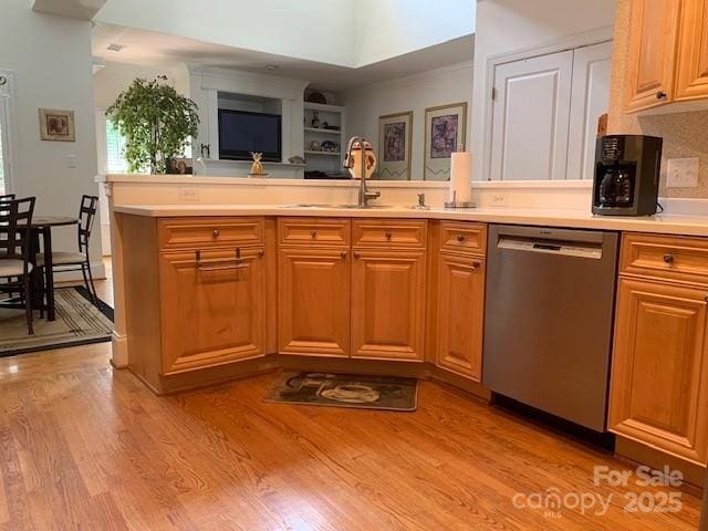 19307 Beaufain St, Cornelius, NC 28031 - kitchen with a peninsula, a sink, light wood-type flooring, stainless steel dishwasher, and light countertops
