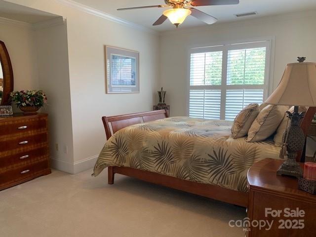 19307 Beaufain St, Cornelius, NC 28031 - bedroom featuring light colored carpet, ornamental molding, visible vents, ceiling fan, and baseboards
