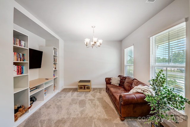 living room featuring light carpet and an inviting chandelier