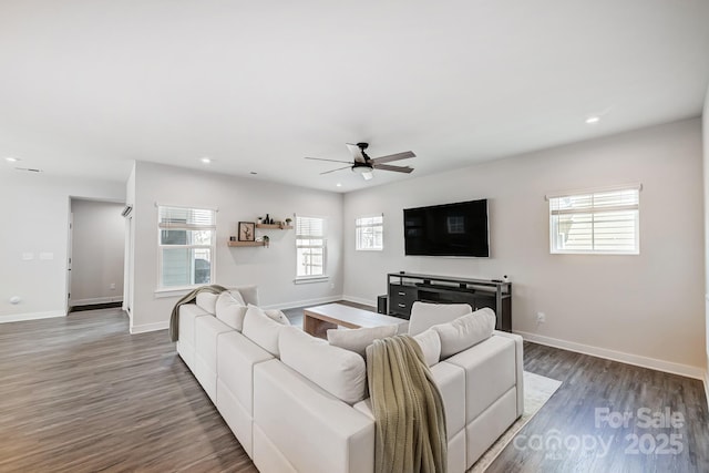 living room with dark hardwood / wood-style floors and ceiling fan