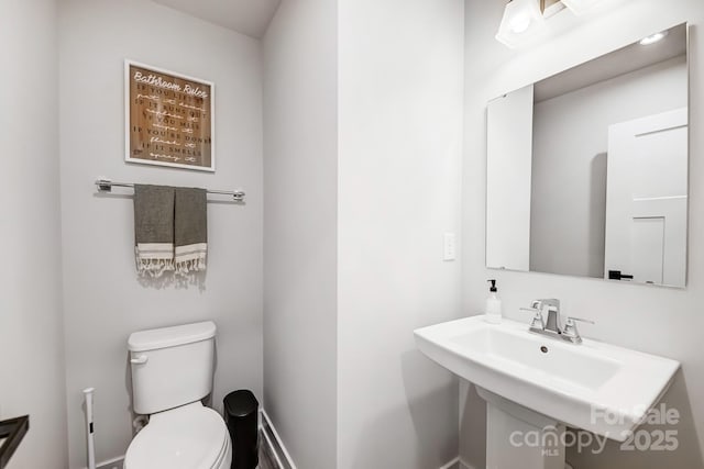 bathroom featuring sink and toilet