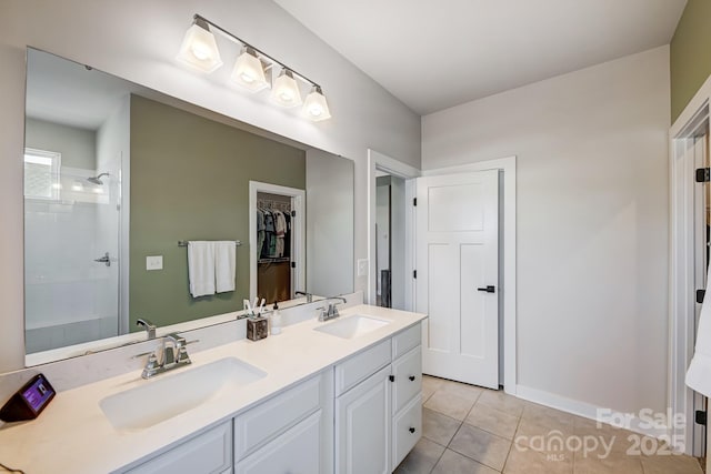 bathroom with a shower, vanity, and tile patterned floors