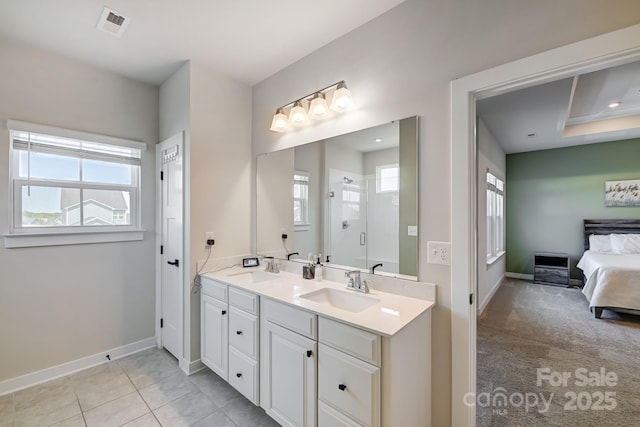 bathroom featuring tile patterned flooring, vanity, and a shower with door