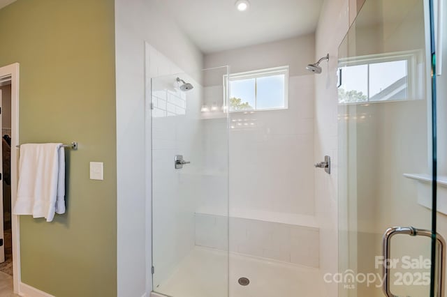 bathroom with a shower with door