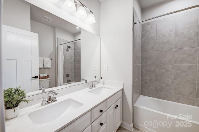 bathroom with shower / tub combo and vanity