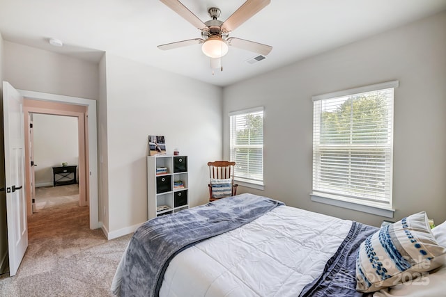 bedroom with ceiling fan and light carpet