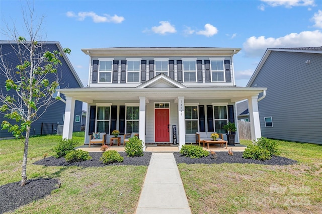 view of front of house with a porch and a front lawn