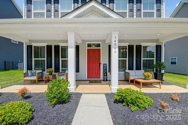 property entrance featuring covered porch and outdoor lounge area