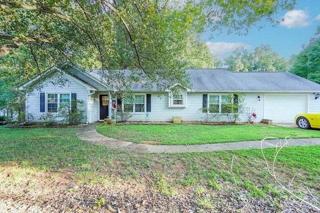 ranch-style house featuring a garage and a front yard