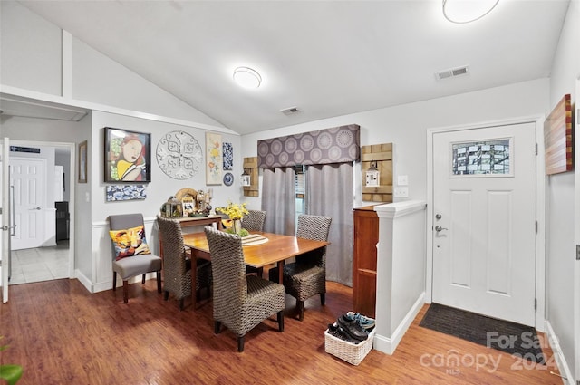 dining room featuring hardwood / wood-style floors and vaulted ceiling