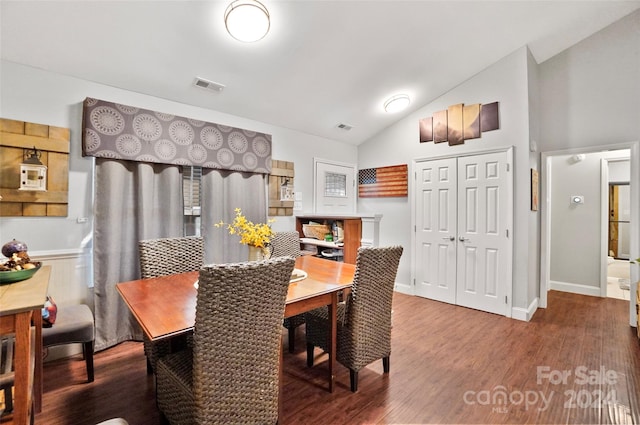 dining area featuring vaulted ceiling and wood-type flooring