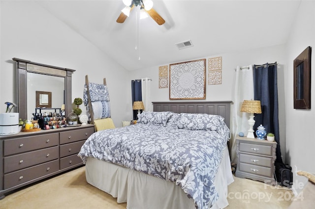 bedroom featuring ceiling fan, vaulted ceiling, and light carpet