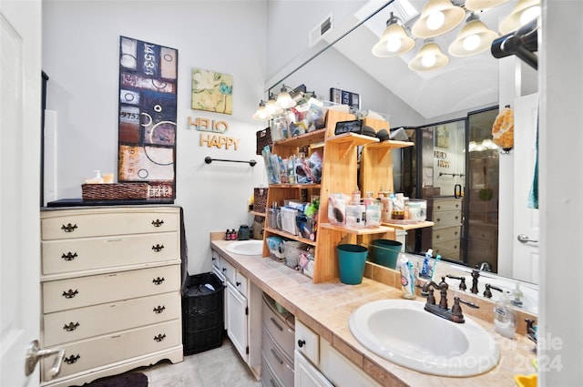 bathroom featuring dual bowl vanity, a chandelier, vaulted ceiling, tile patterned flooring, and a shower with door