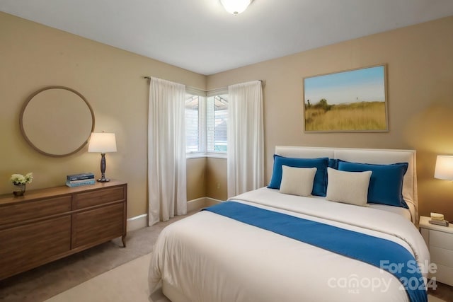 bedroom featuring carpet and baseboards