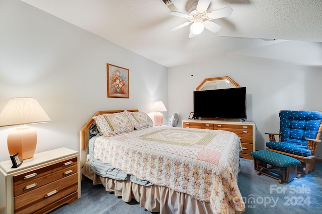 bedroom featuring ceiling fan, a textured ceiling, and carpet flooring