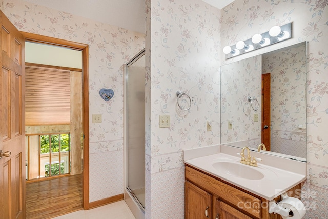 bathroom with an enclosed shower, vanity, and wood-type flooring