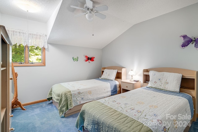 bedroom with ceiling fan, vaulted ceiling, a textured ceiling, and carpet floors