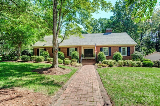 single story home featuring a front lawn