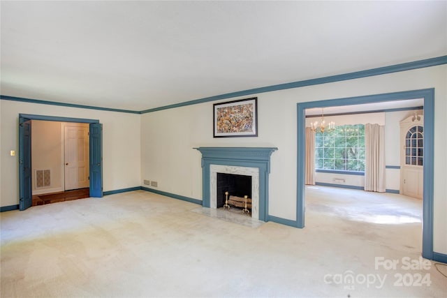 unfurnished living room featuring light carpet, a notable chandelier, a premium fireplace, and ornamental molding