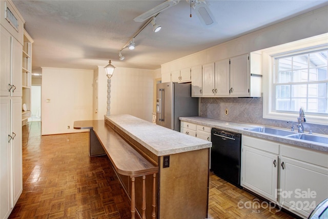 kitchen featuring track lighting, white cabinetry, dark parquet flooring, and dishwasher