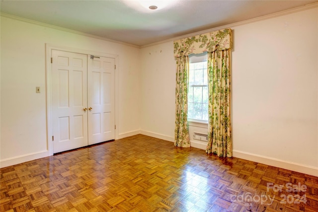 unfurnished bedroom with crown molding and parquet flooring