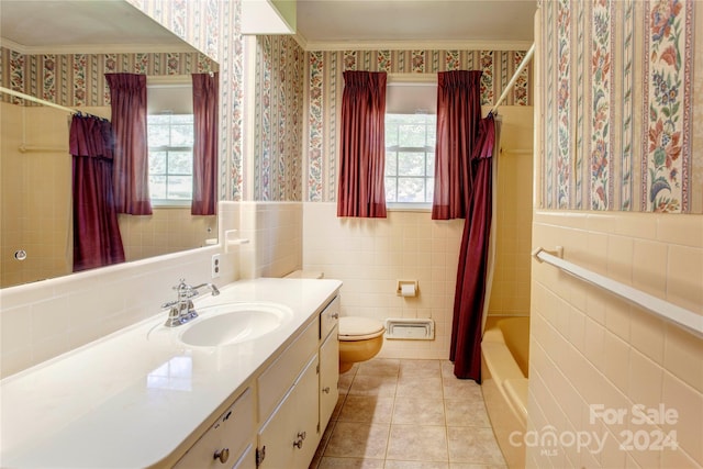 full bathroom with tile walls, toilet, tile patterned flooring, vanity, and shower / tub combo