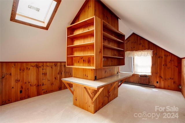 bonus room featuring wood walls, carpet floors, baseboard heating, and vaulted ceiling with skylight