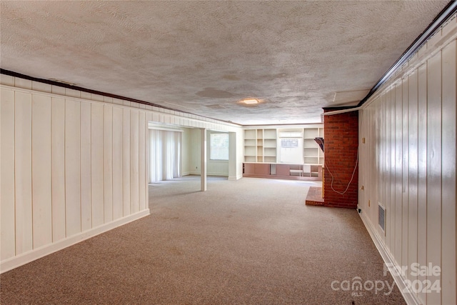 spare room with carpet flooring and a textured ceiling