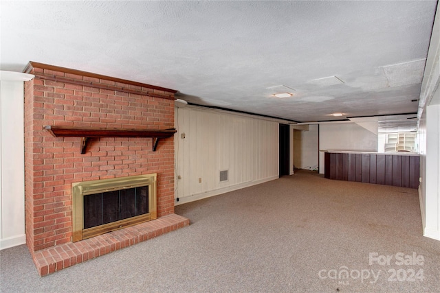 unfurnished living room featuring light carpet, a fireplace, and a textured ceiling